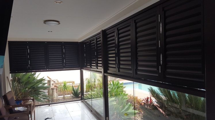 Black Shutters Over Glass Railing — Shutters in Bundaberg, QLD