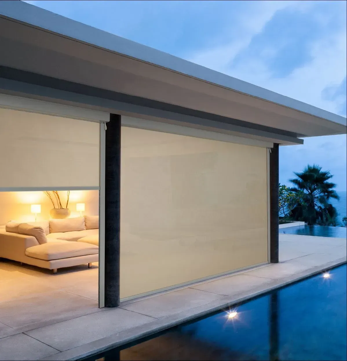Dropdown Awnings Around The Pool At Night — Shutters in Bundaberg, QLD