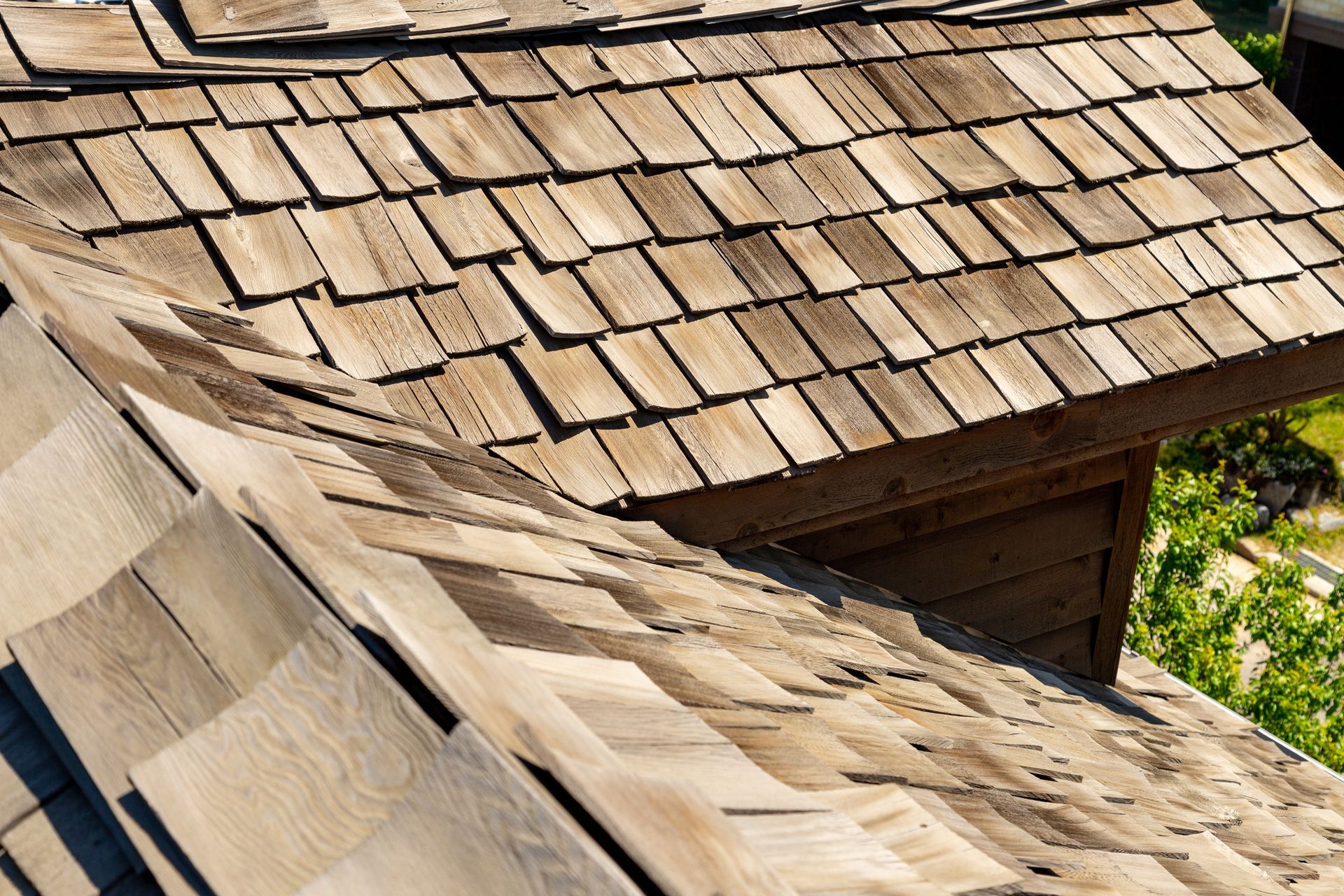Wood-shingled rooftop with natural texture under bright daylight.