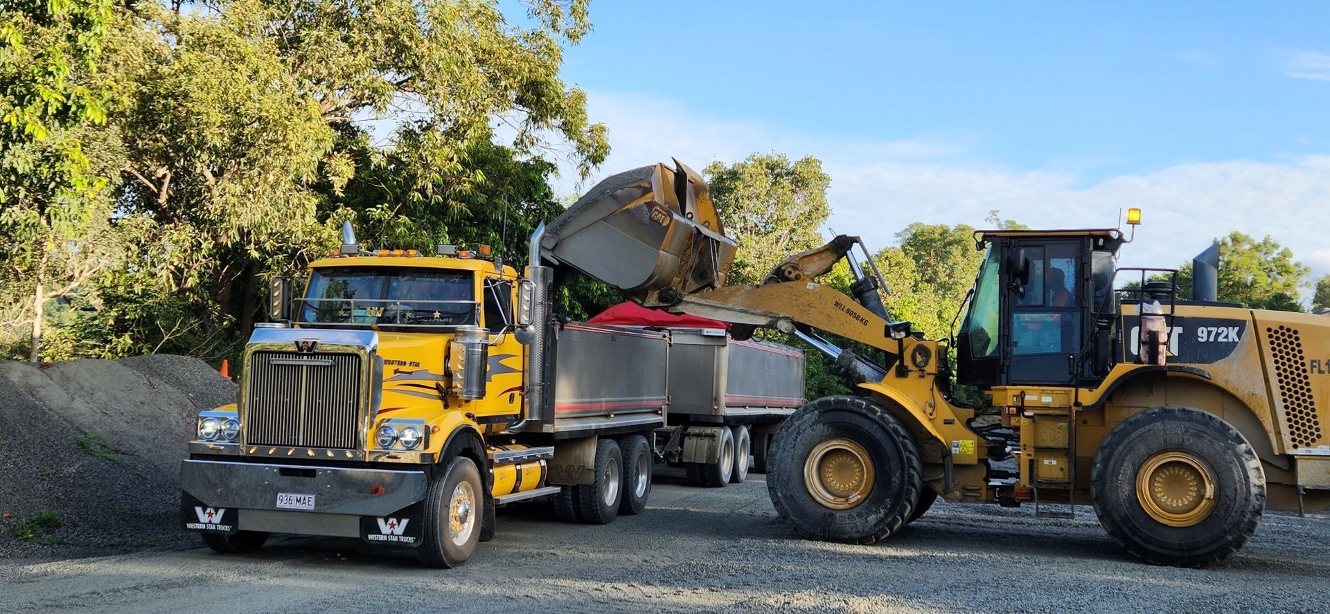 A Yellow Truck Is Being Towed By A Bulldozer — Petersen Tippers in Farleigh, QLD
