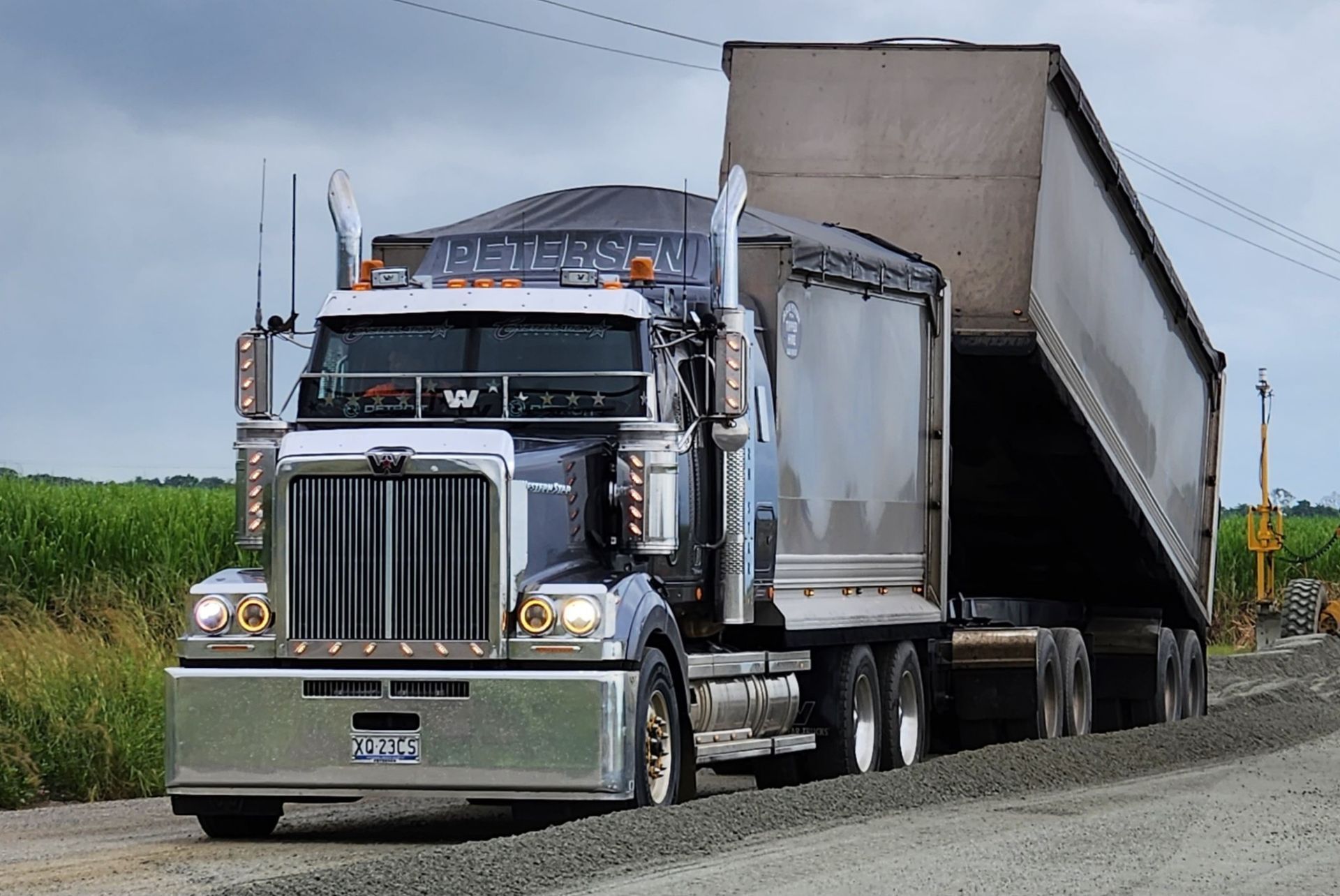 A Semi Truck Is Driving Down A Gravel Road — Petersen Tippers in Farleigh, QLD