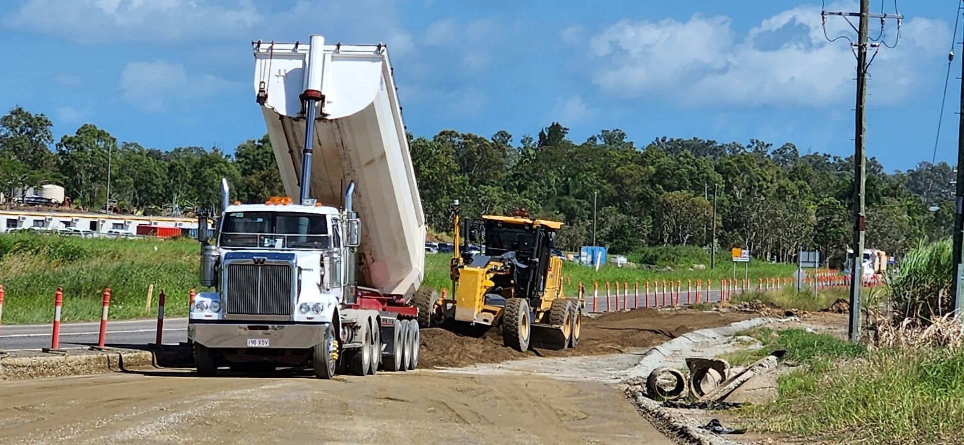 A Dump Truck Is Being Loaded With Dirt On A Construction Site — Petersen Tippers in Farleigh, QLD