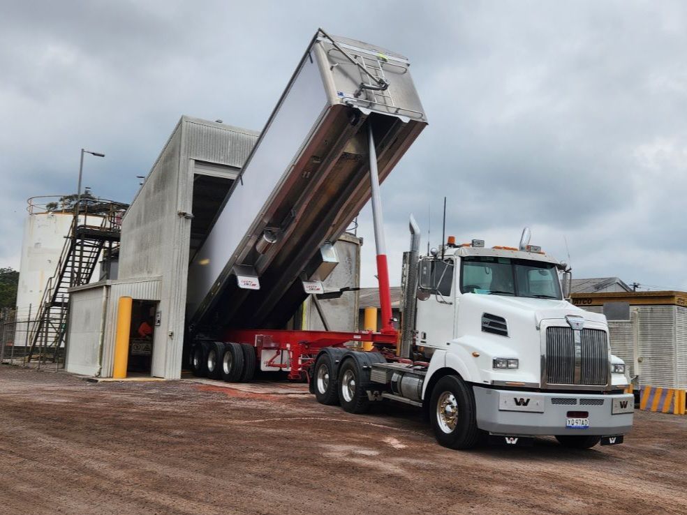 A Dump Truck Is Being Loaded With Dirt In A Parking Lot — Petersen Tippers in Farleigh, QLD