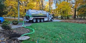 Septic tank pumping in progress using specialized vacuum truck equipment