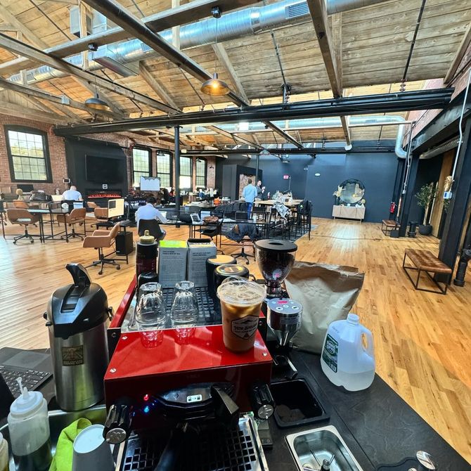 A large room with a lot of people sitting at tables