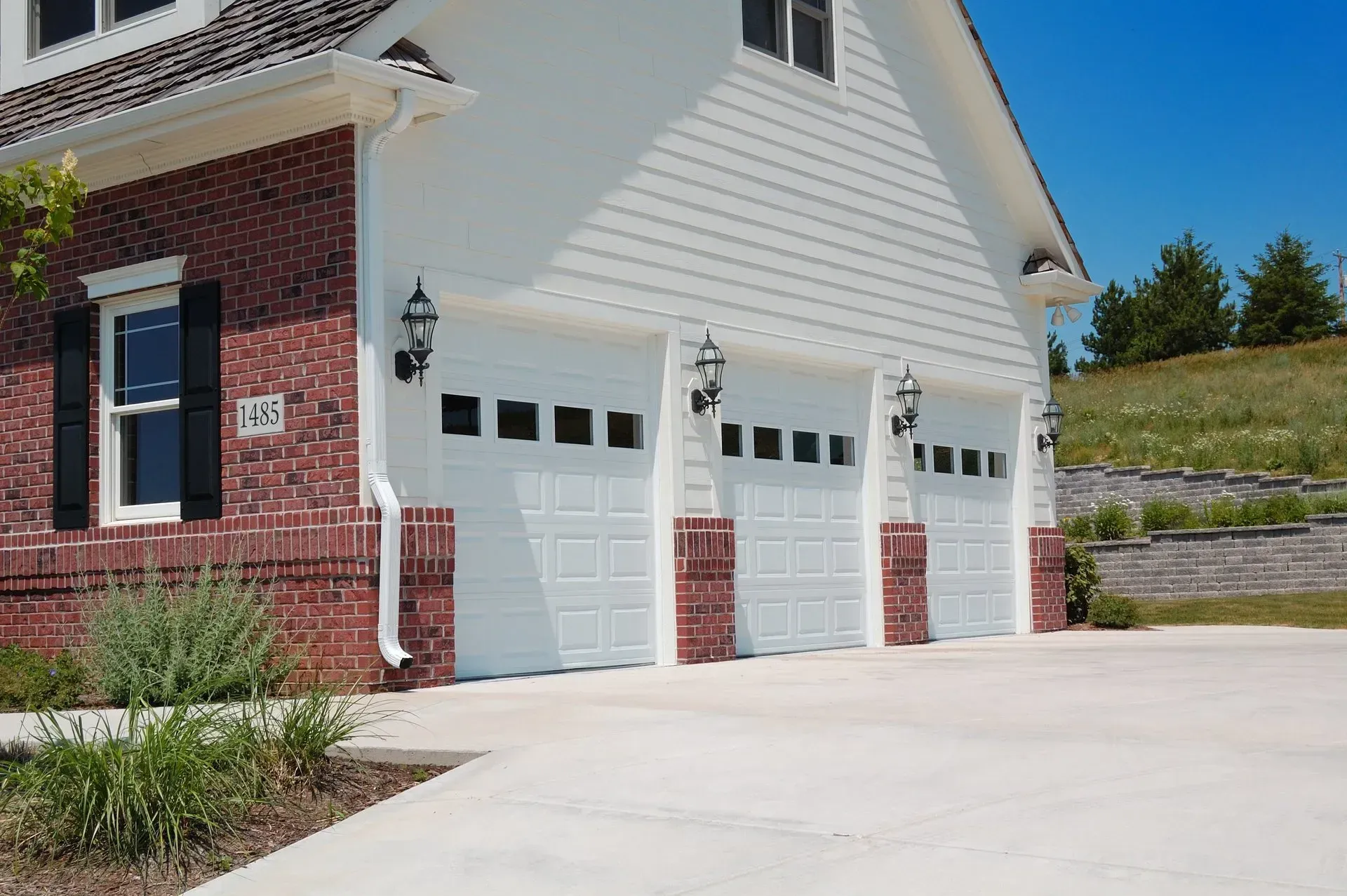 A home with three white garage doors.
