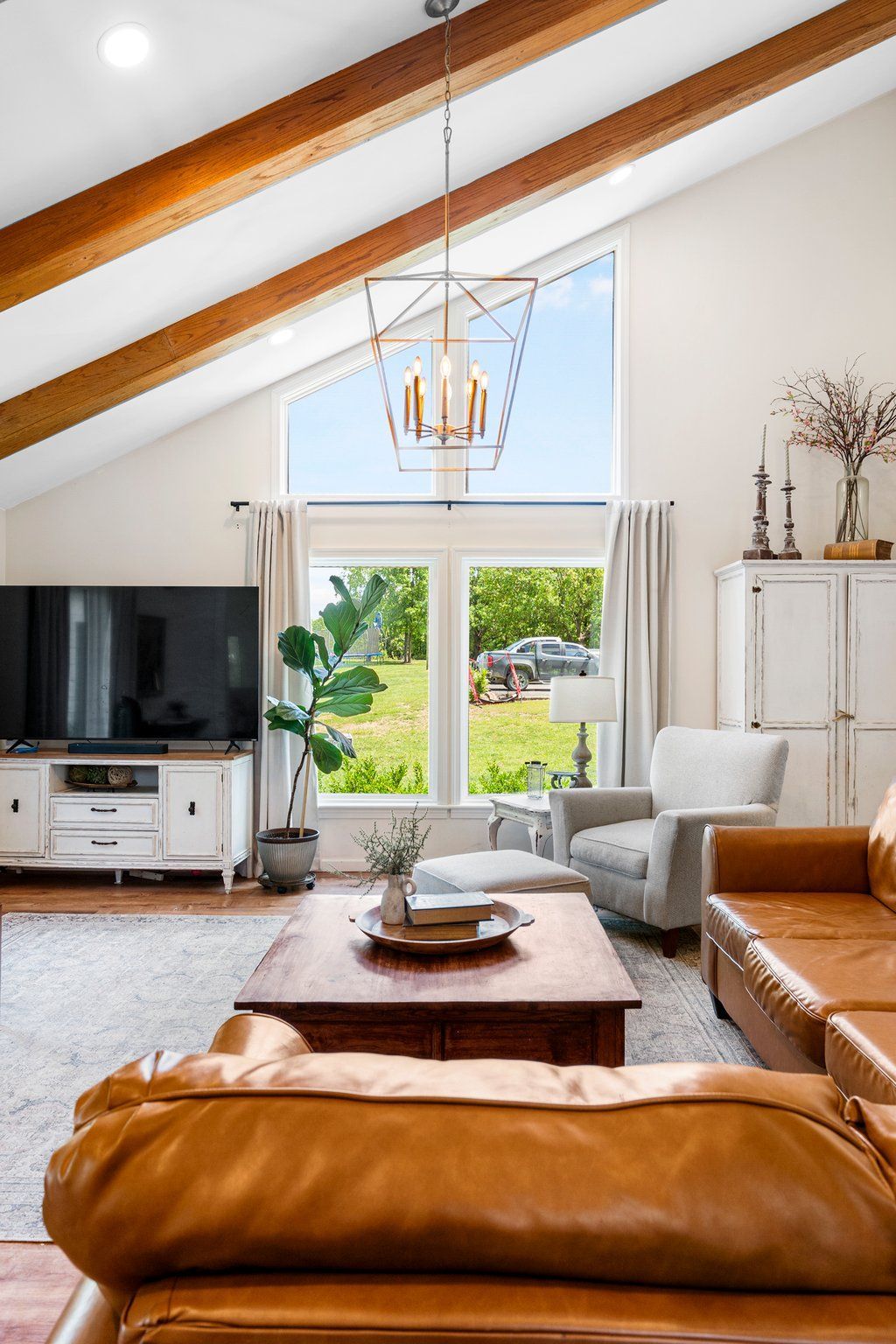 A photo of a modern home with wood beams on a slanted ceiling.
