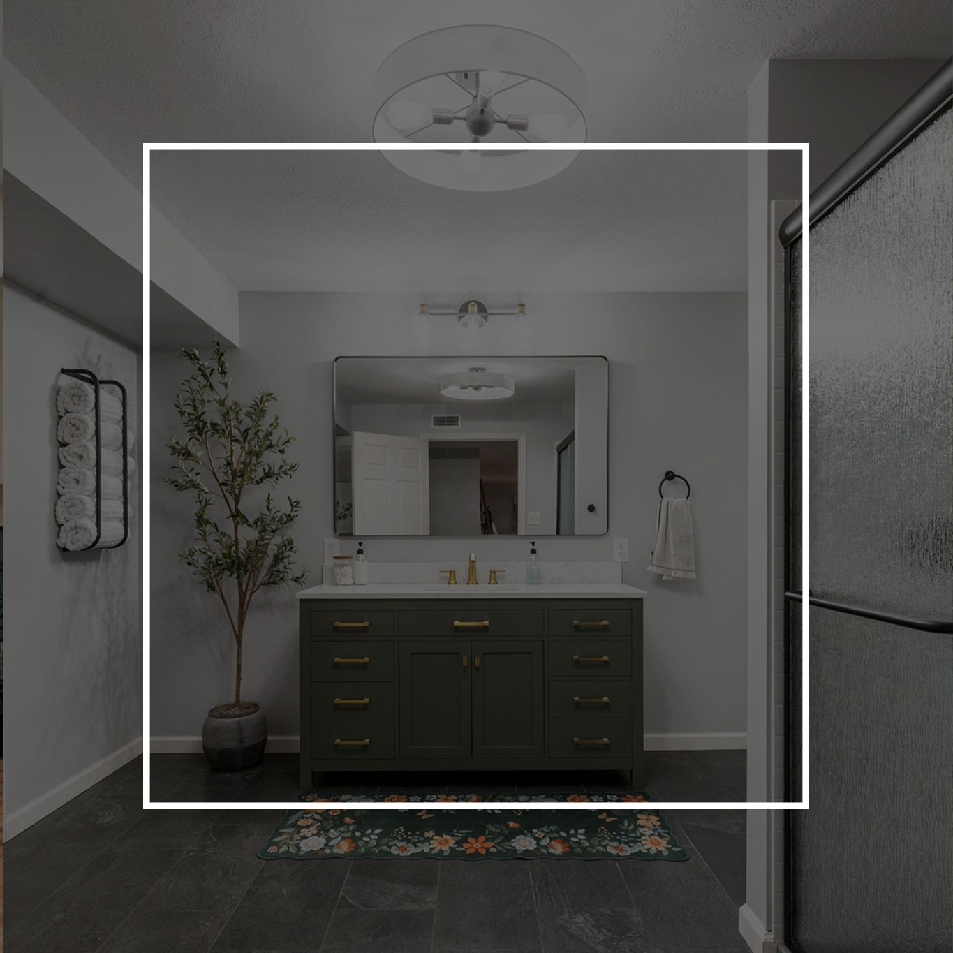 Bathroom with green vanity, large mirror, and plant.