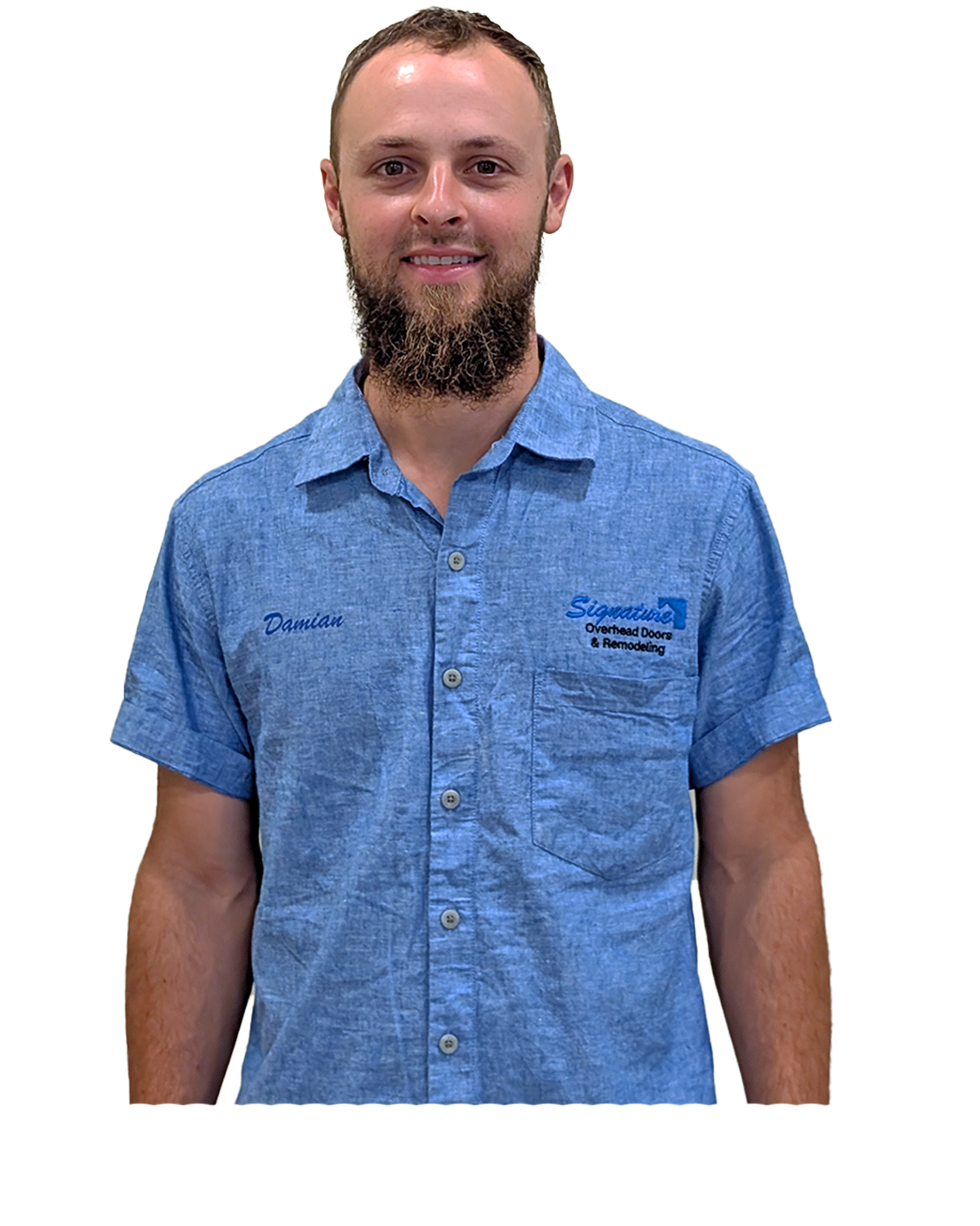 Man in a blue button-down shirt with beard smiling at the camera. A logo is visible on the shirt.