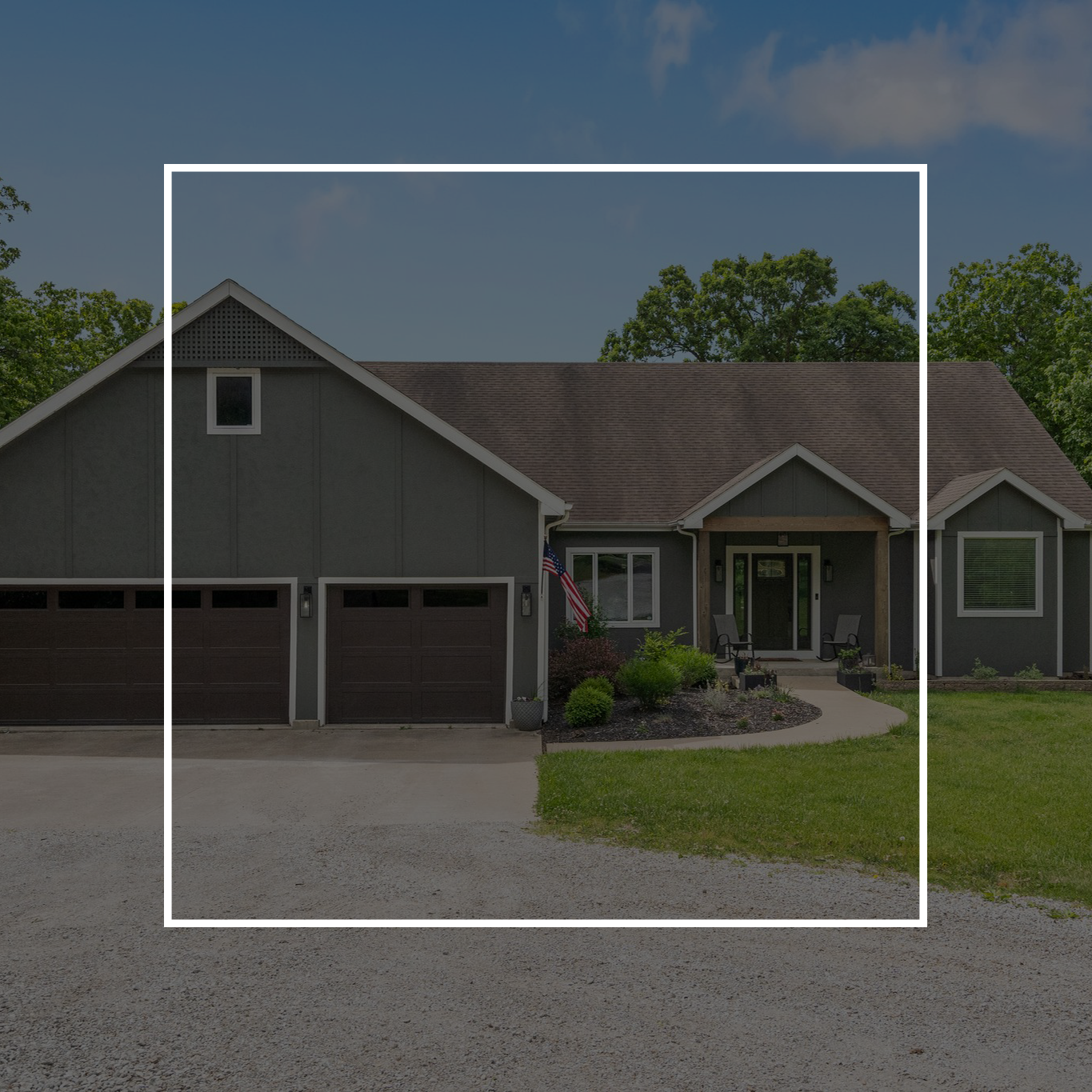 Gray house with brown garage doors and a pathway leading to the front door.
