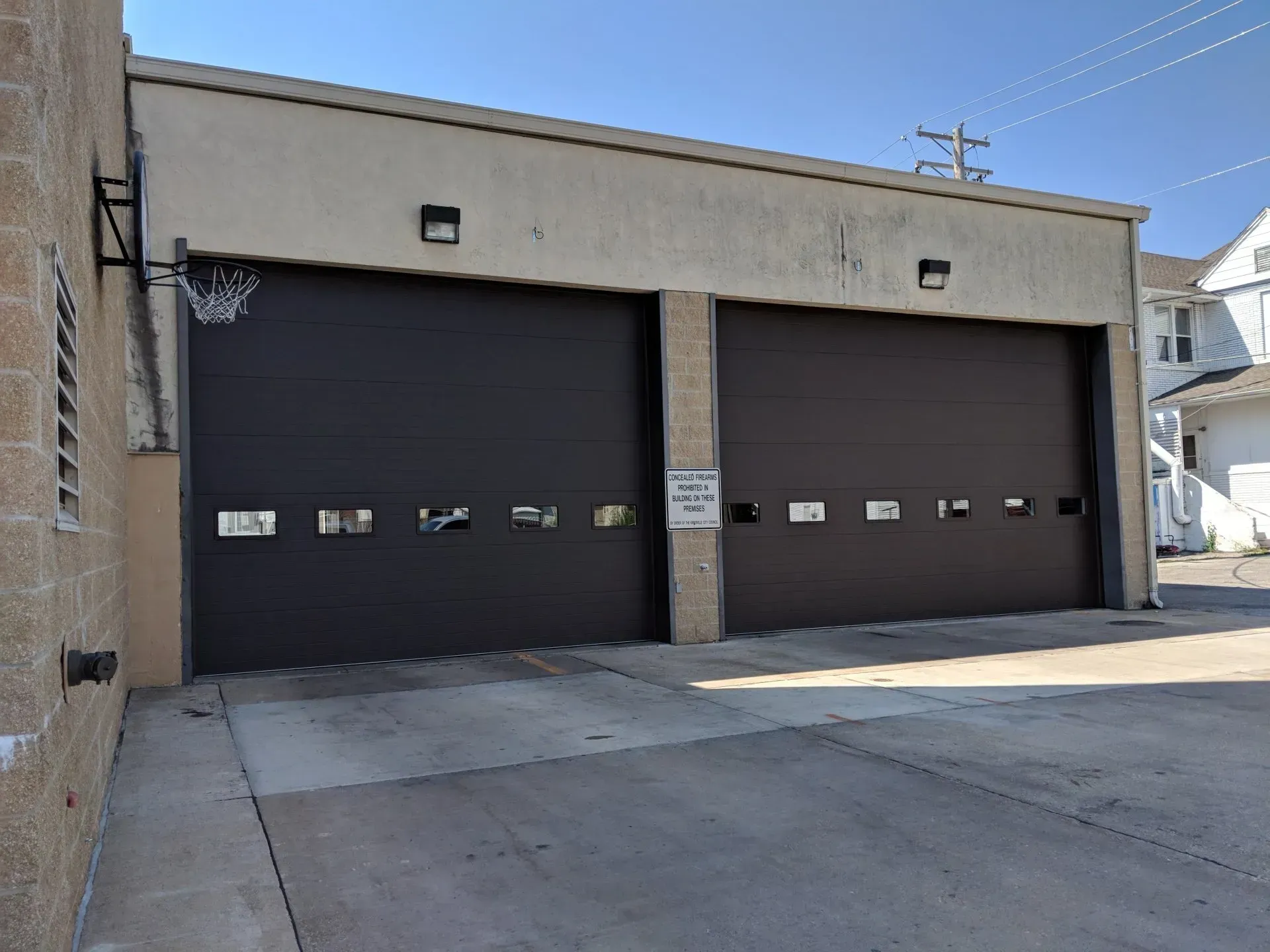 Two brown commercial garage doros with windows.