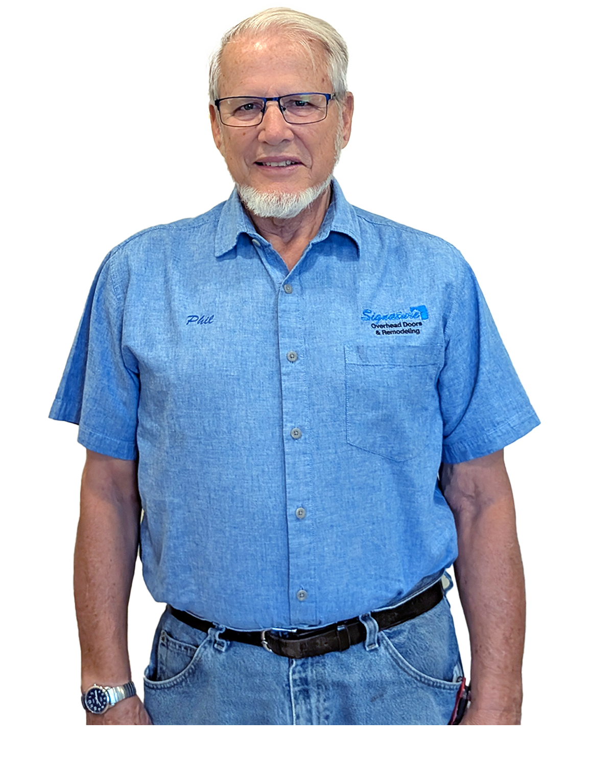 Man in blue work shirt, glasses, and jeans, smiling; stands in front of a white background.