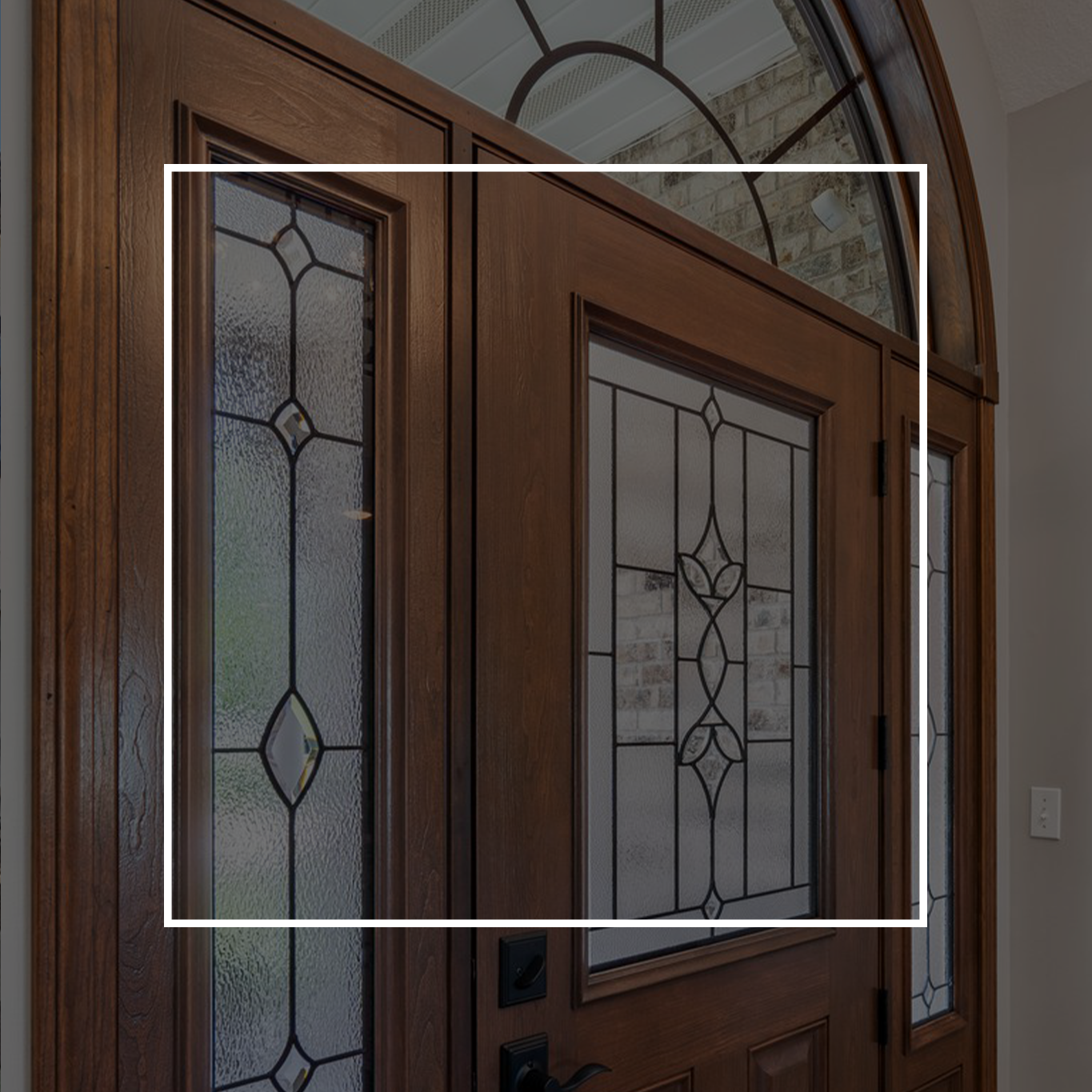 An exterior door with a white square outline on top.