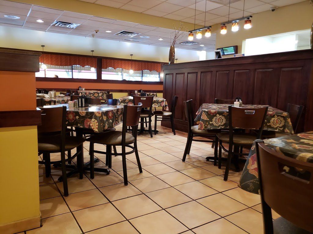 The inside of a restaurant with tables and chairs