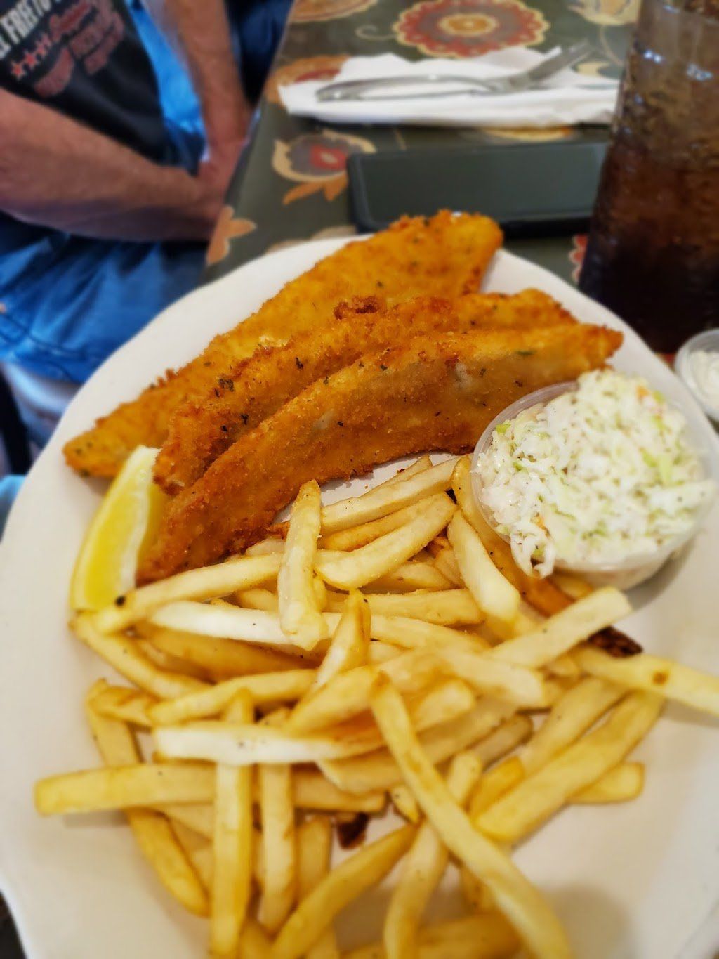 A white plate topped with fish and french fries