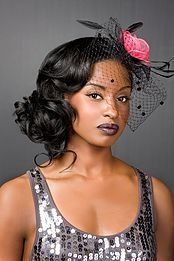 A woman wearing a veil and a flower in her hair.