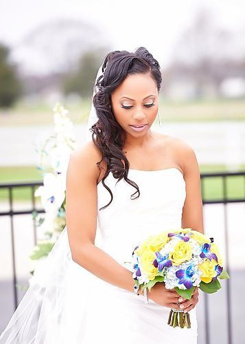 A woman in a wedding dress is holding a bouquet of flowers