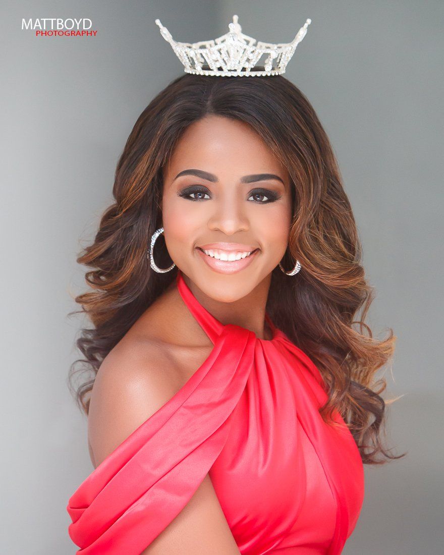 A woman in a red dress with a crown on her head