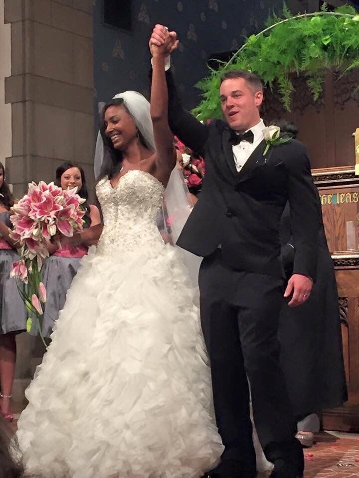 A bride and groom are holding hands in a church
