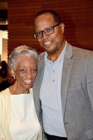 Man and woman smiling, indoors