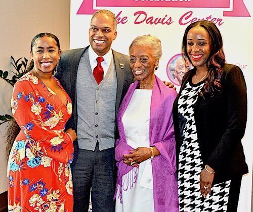 Group of four people posing for a photo at an event