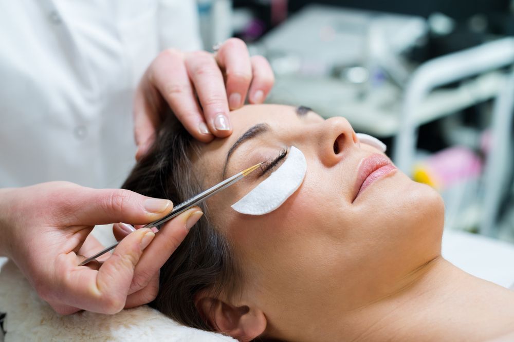 A Woman Is Getting Her Eyelashes Done At A Beauty Salon — Doubleview Health & Beauty In Elanora, QLD