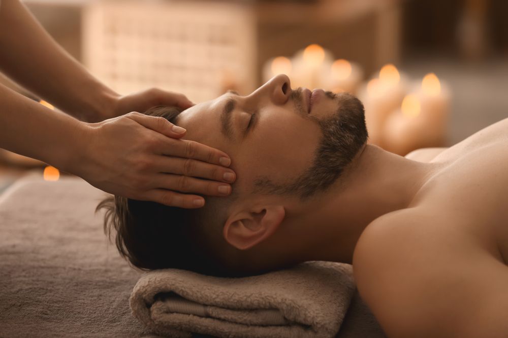A Man Is Getting A Head Massage At A Spa — Doubleview Health & Beauty In Elanora, QLD