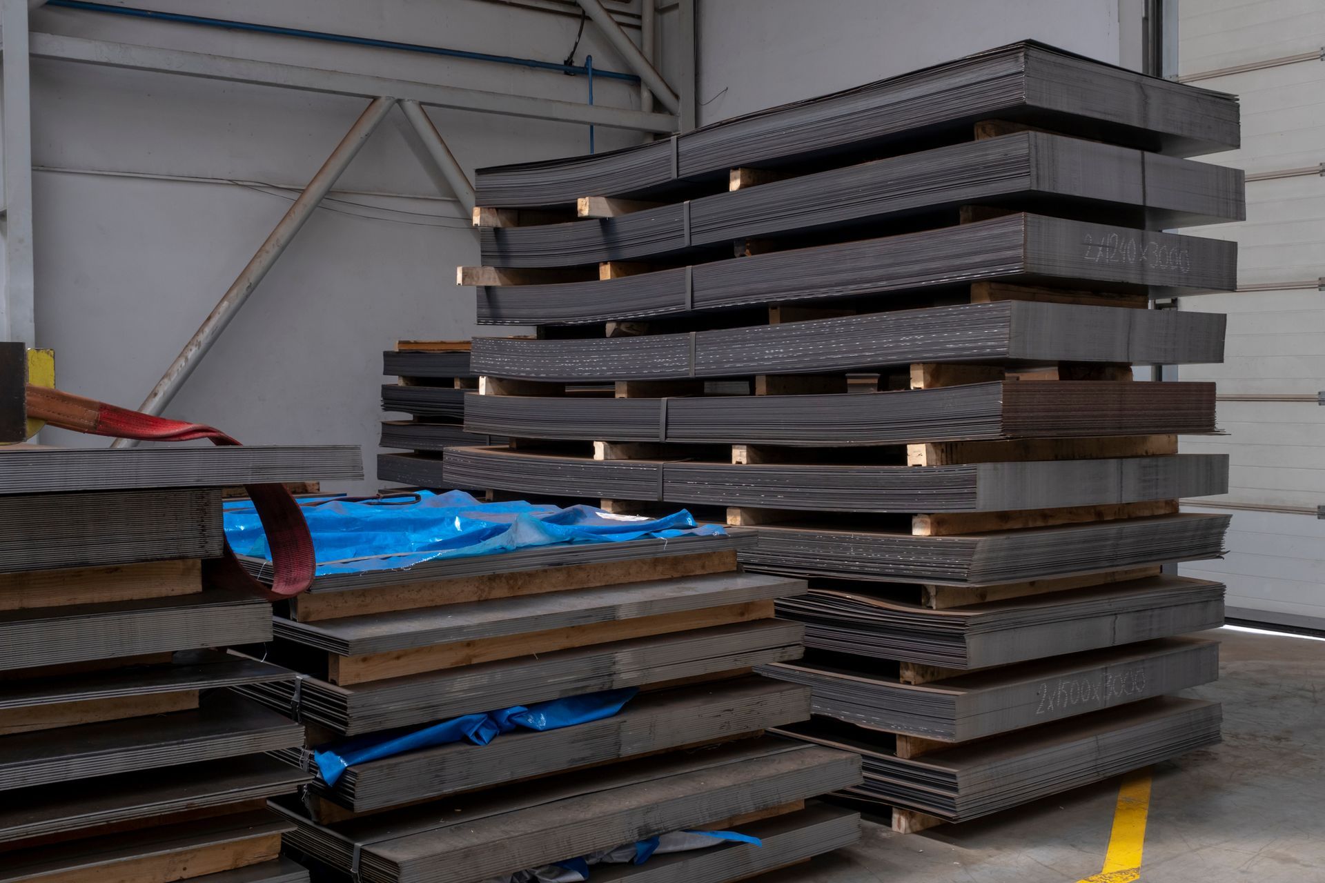 Picture of metal sheets stacked in the warehouse.