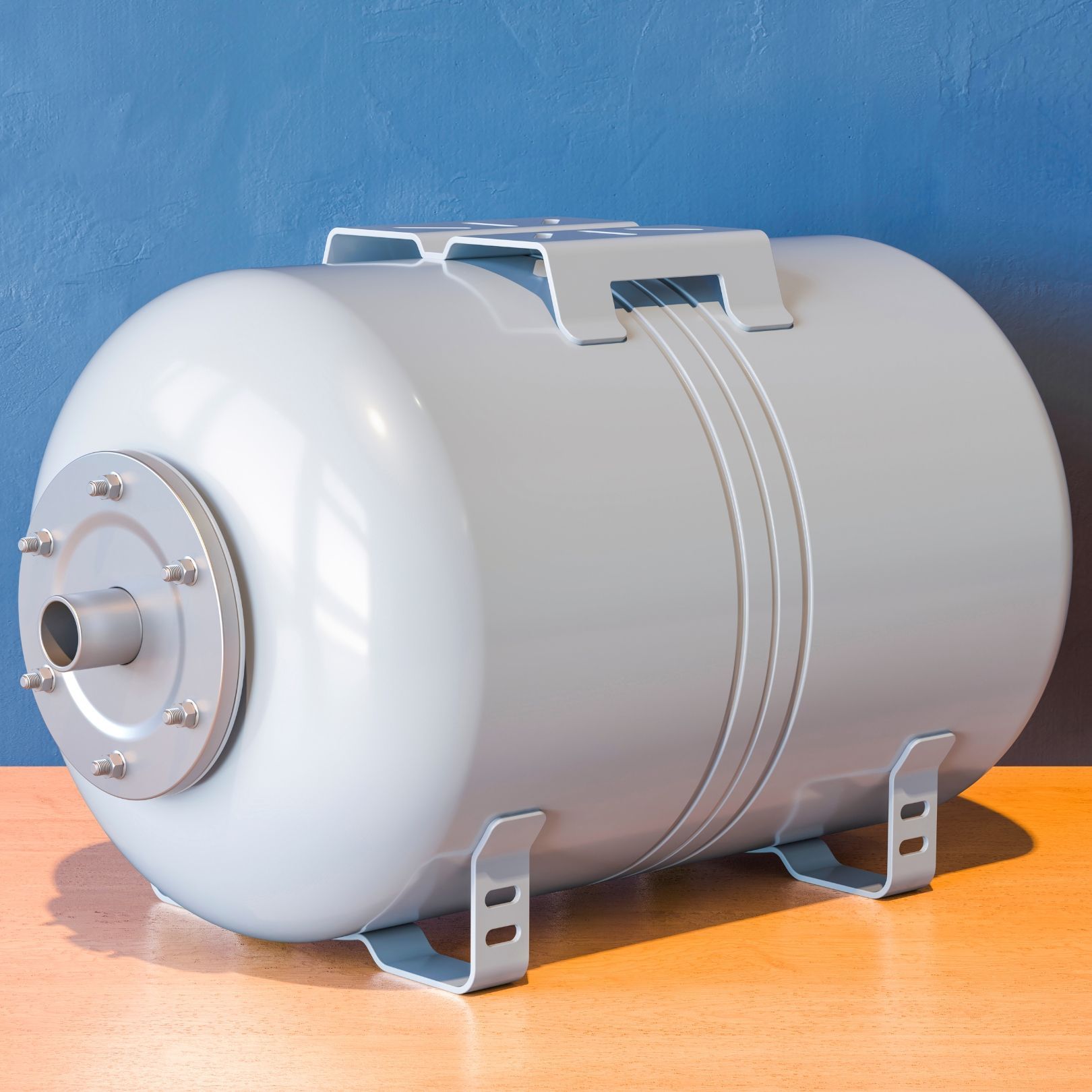 Gray cylindrical pressure tank on an orange surface against a blue background