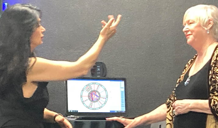 Astrologer, Patricia Rogers (R), gives reading to guest  at Dime Industries holiday party in Irvine, Ca.