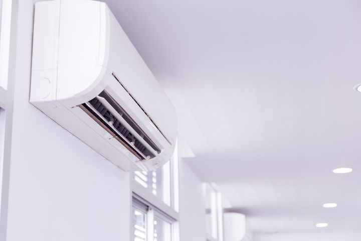 Wall-mounted air conditioner installed by local heating and cooling company for efficient cooling service

