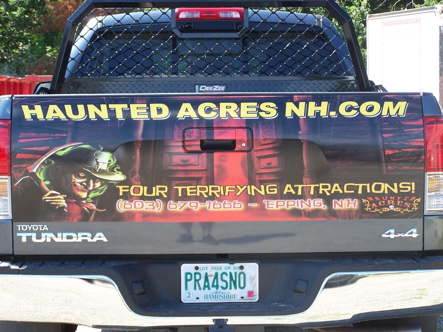 The back of a toyota tundra truck advertising haunted acres nh.com