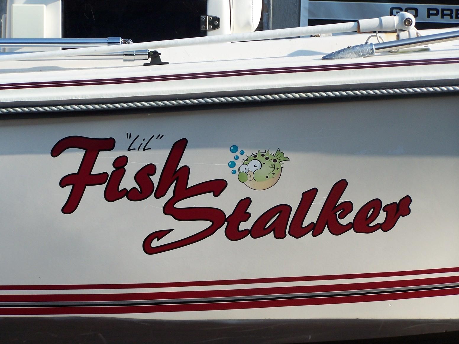 A boat with the name fish stalker painted on it
