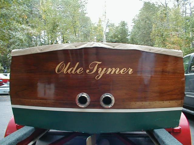 A wooden boat with the name olde tymer on it