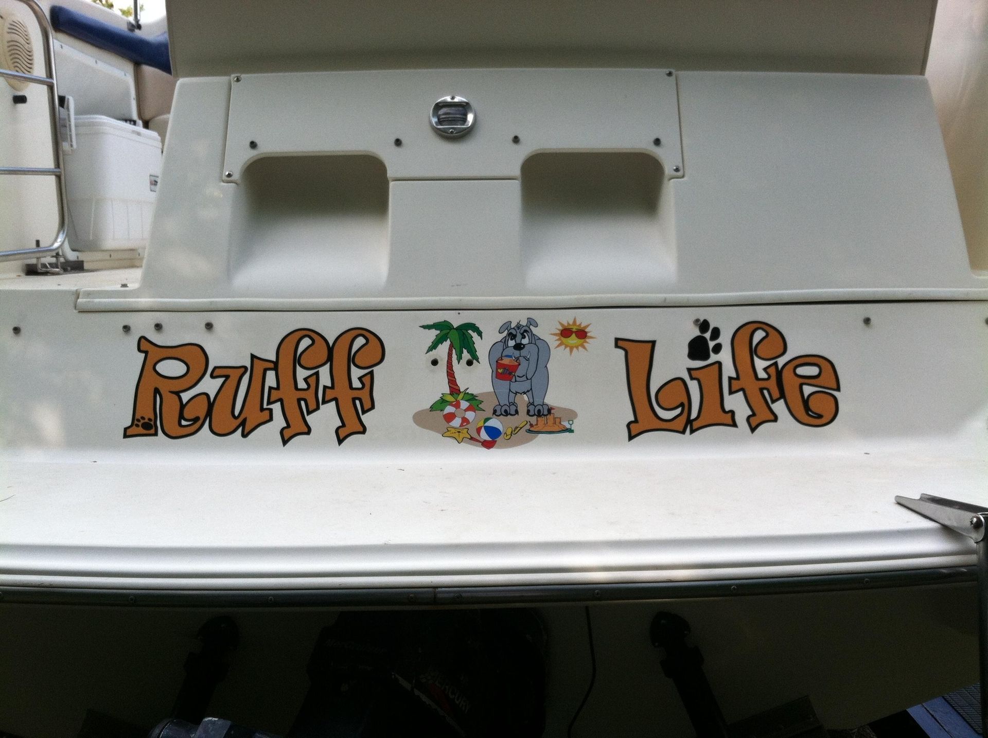 A boat has a sticker on the back that says ruff life