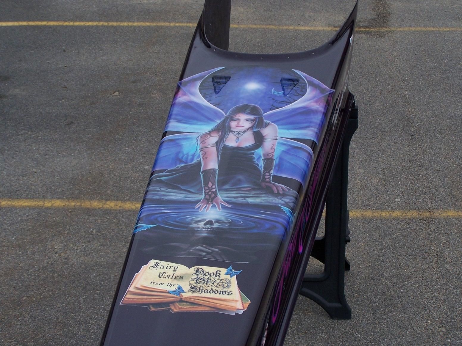 A painting of a fairy on the side of a motorcycle