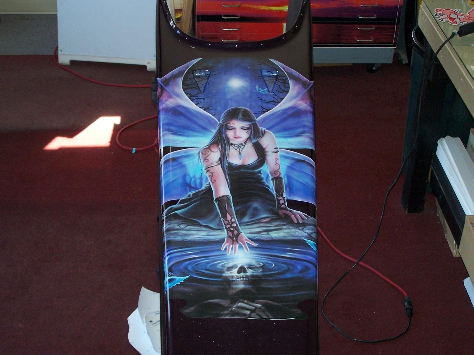 A painting of a woman with wings on a table