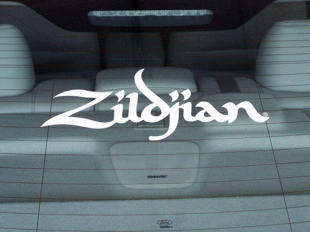 A zildjian logo is on the back window of a car