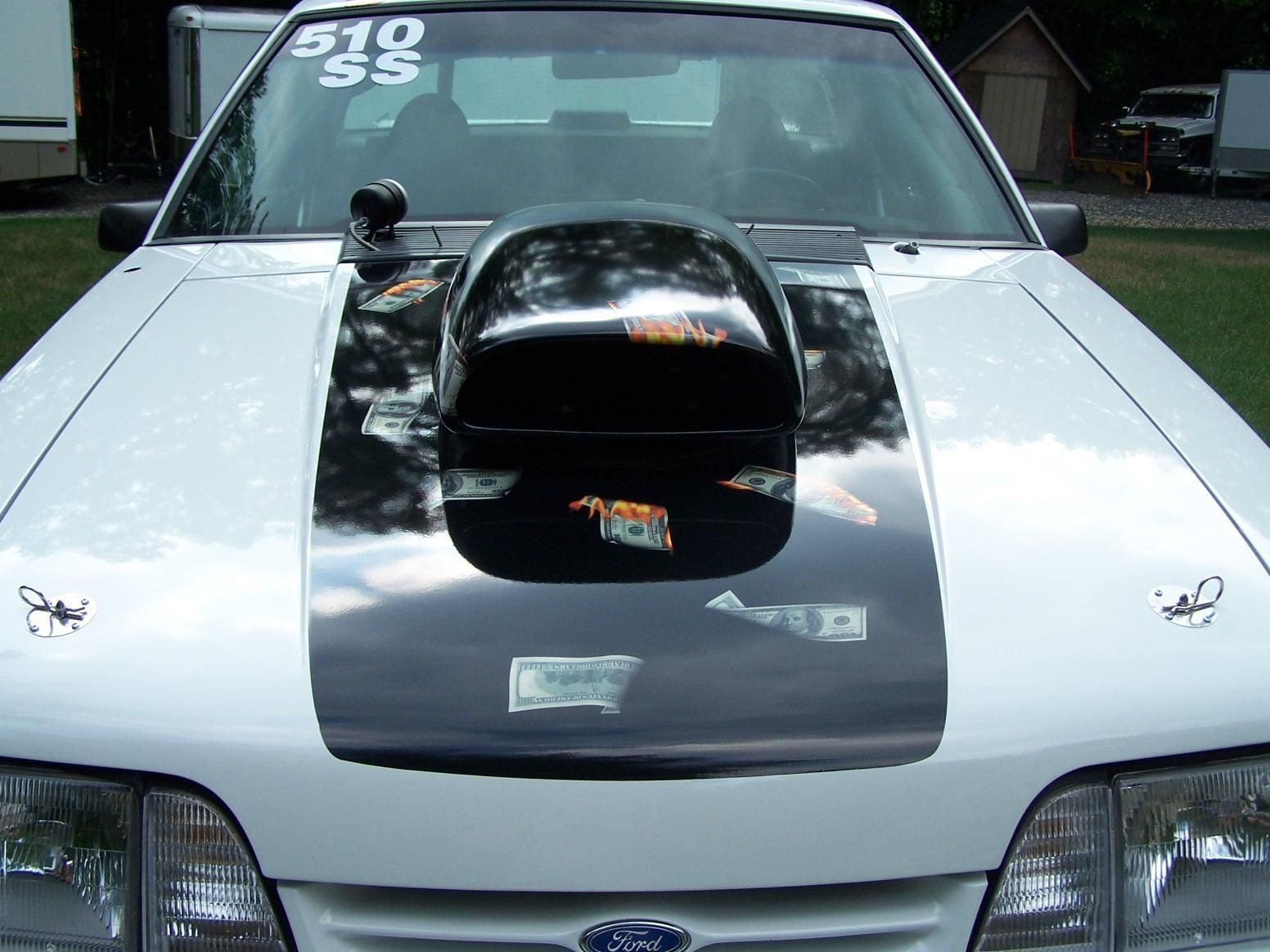 A white ford mustang with the number 510 on the windshield