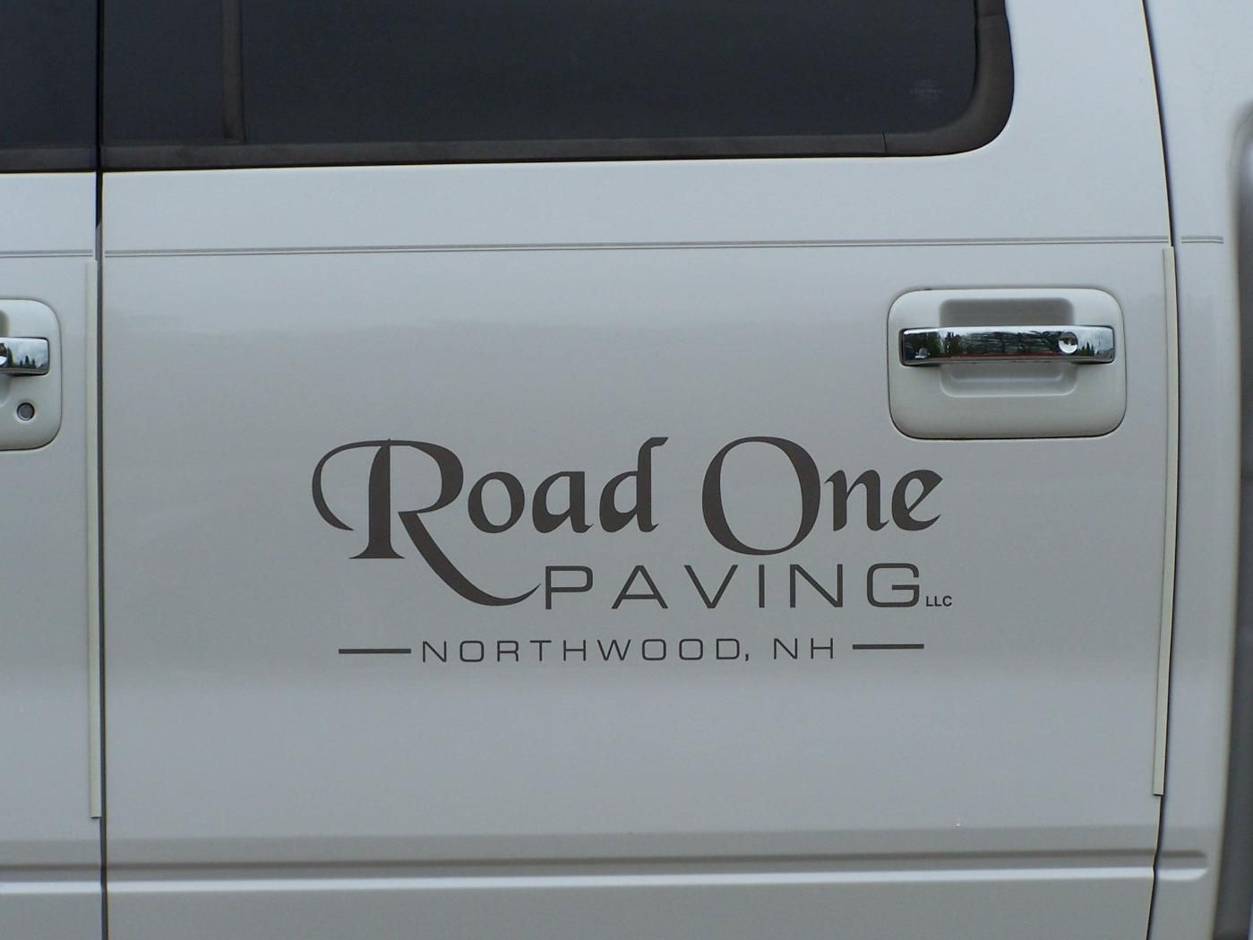 A white truck with the word road one paving on the side