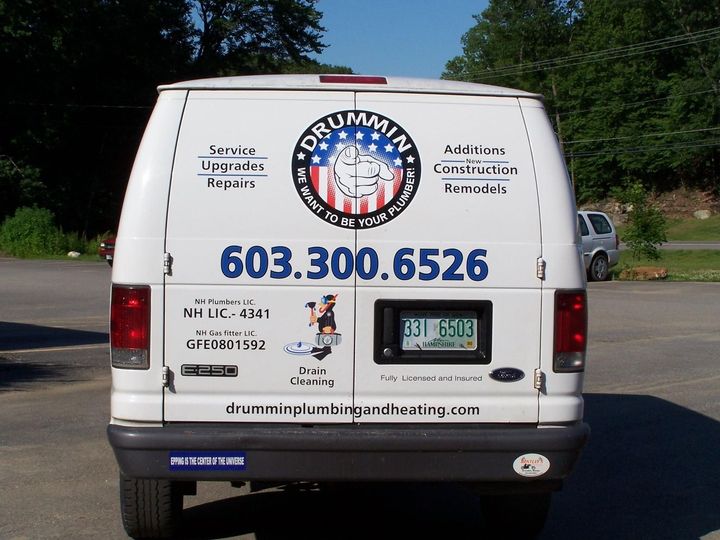 A white van with drumming plumbing written on the back