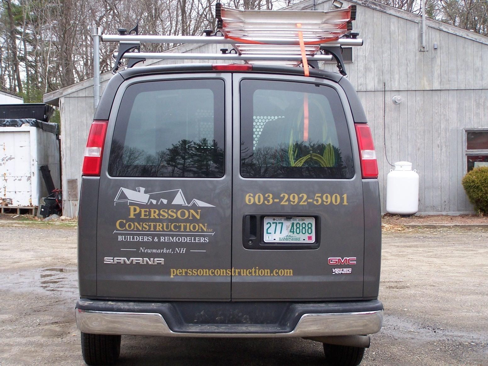 A persson construction van is parked in a parking lot