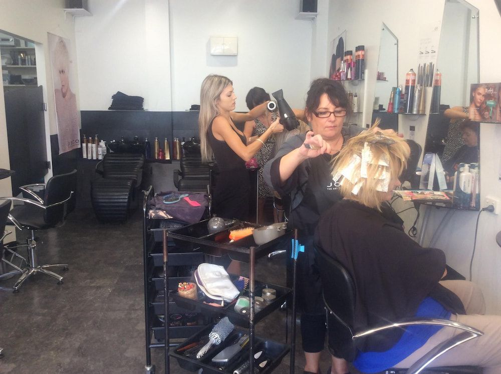 A Woman is Getting Her Hair Dyed in a Salon — Coolum Cutting Edge in Coolum, QLD