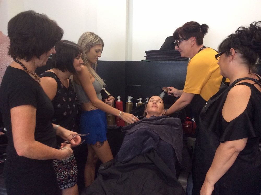Group of Women Are Standing Around a Woman Getting Her Hair Cut — Coolum Cutting Edge in Peregian, QLD