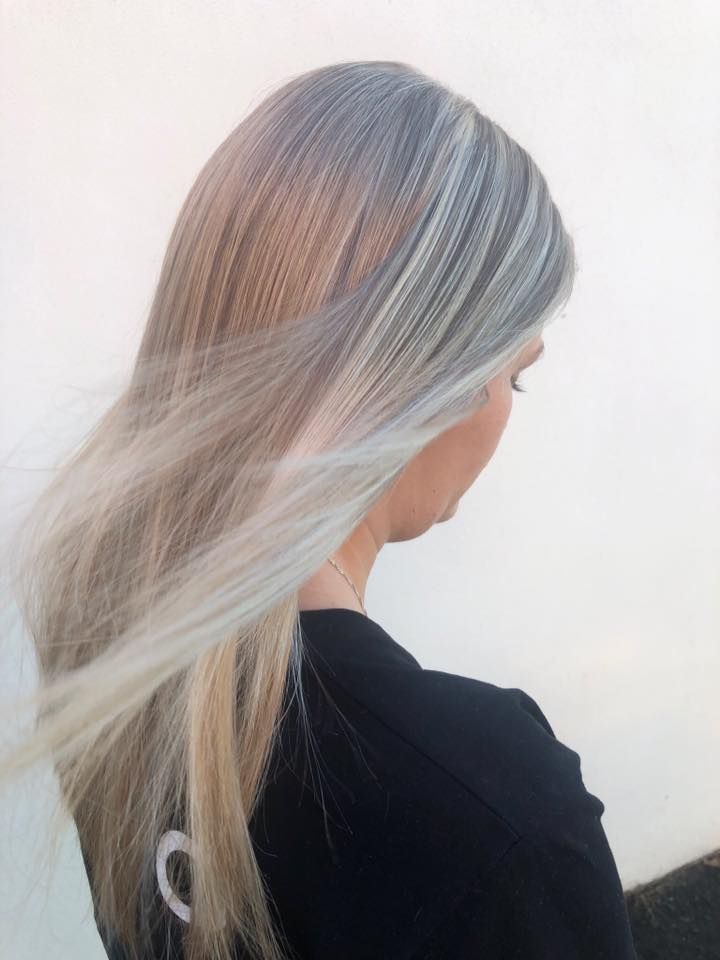 A Woman With Long Blonde Hair is Wearing a Black Shirt — Coolum Cutting Edge in Doonan, QLD