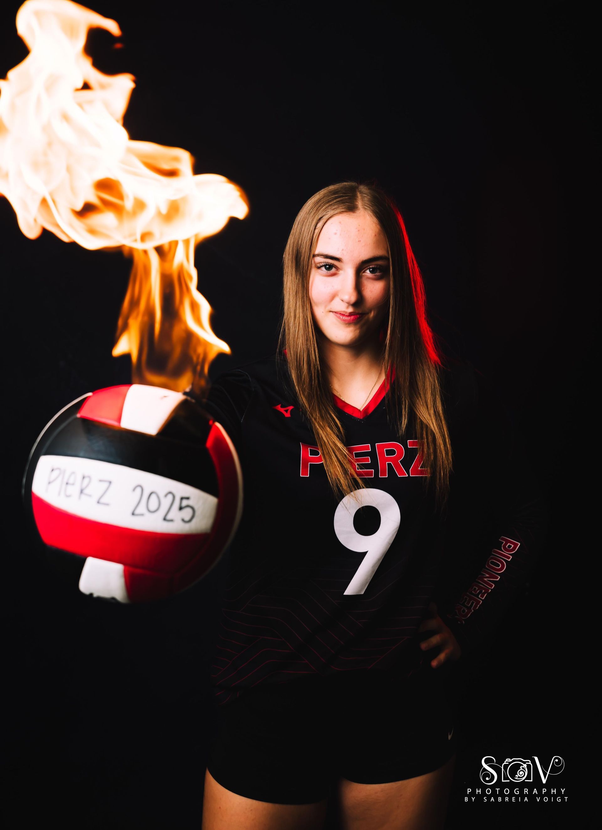 Volleyball player with fiery volleyball, wearing black jersey with 