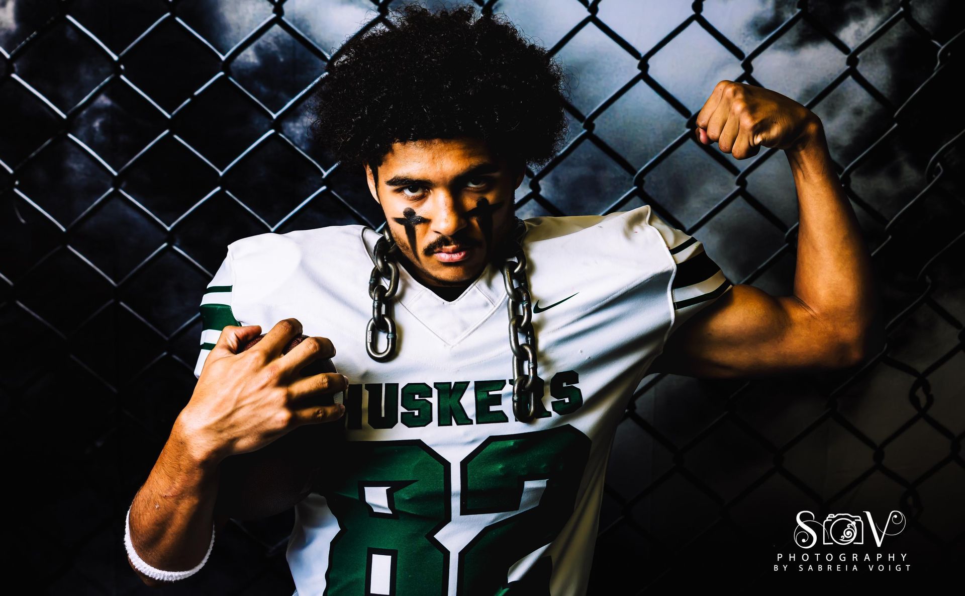 Football player flexing biceps, wearing 