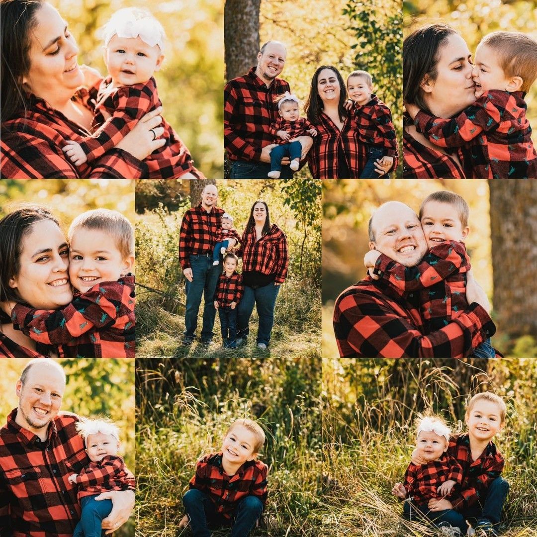 Family in red and black plaid shirts posing outdoors in a wooded area, embracing and smiling.