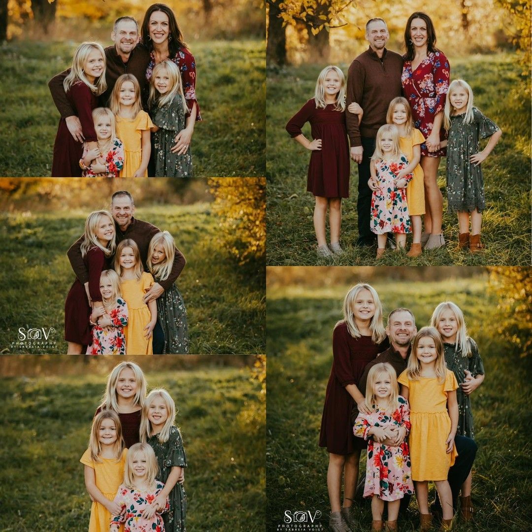 Family portrait outdoors; two adults, three young girls. Adults embrace, girls smile. Autumn foliage.