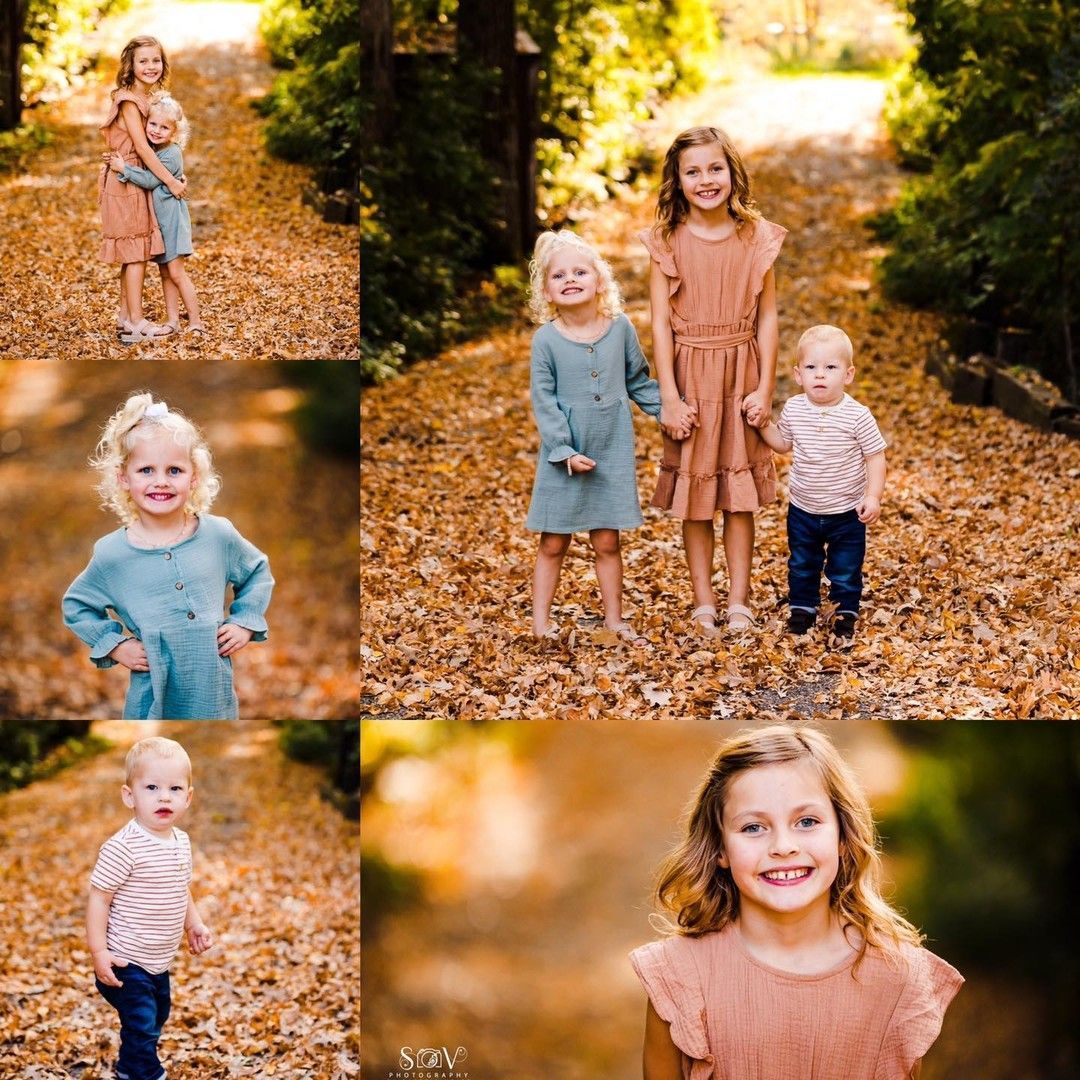 Children in fall outfits pose on a path covered in leaves.